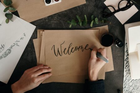 Hand written sign: "Welcome" to Behind Finance Blog